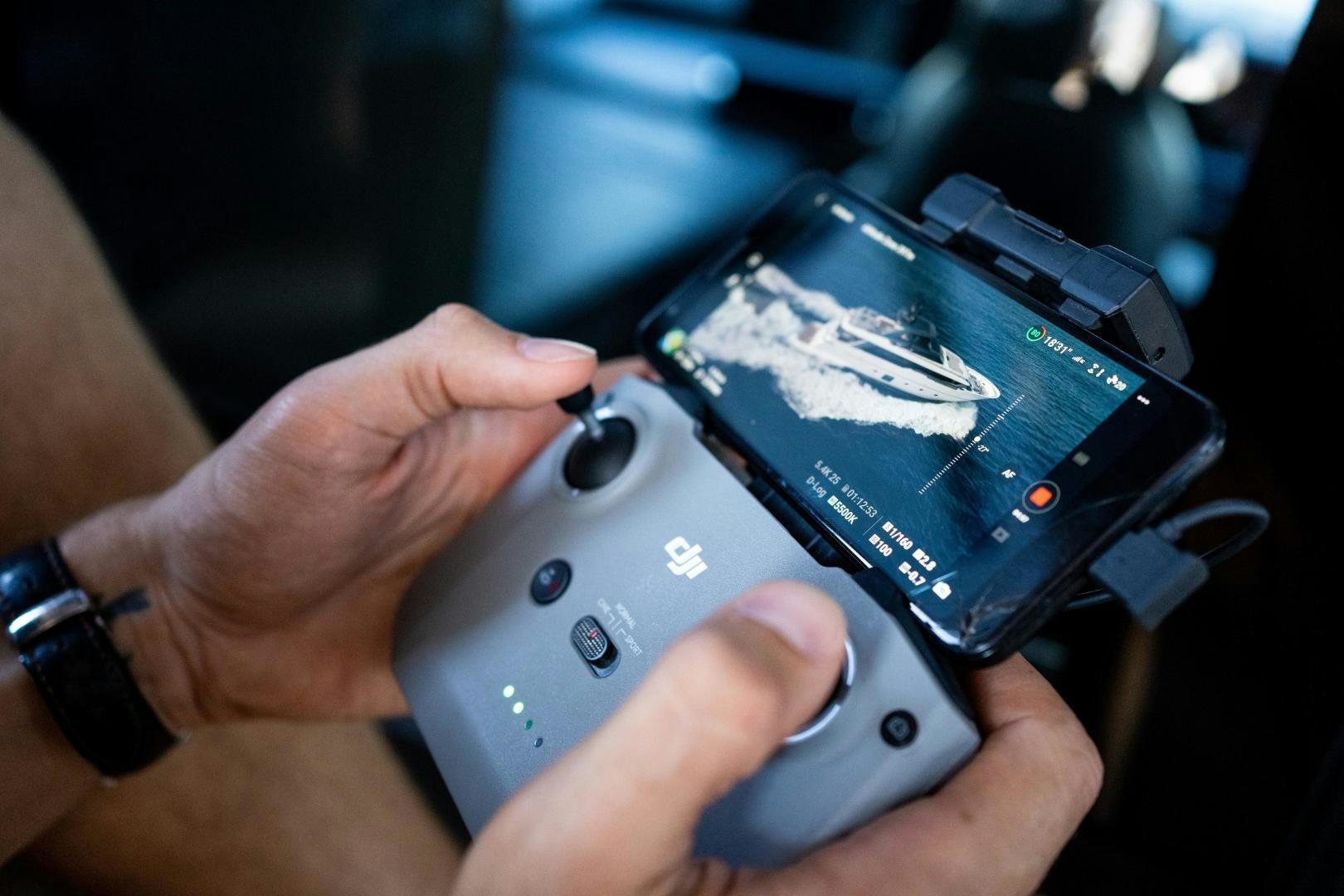 a person holding a cell phone aboard ACE Yacht for Sale