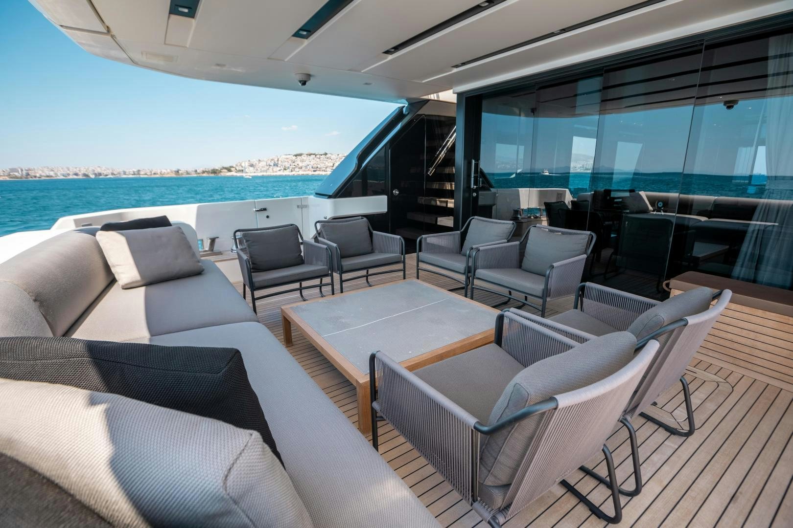 a room with a table chairs and a view of the ocean aboard ACE Yacht for Sale