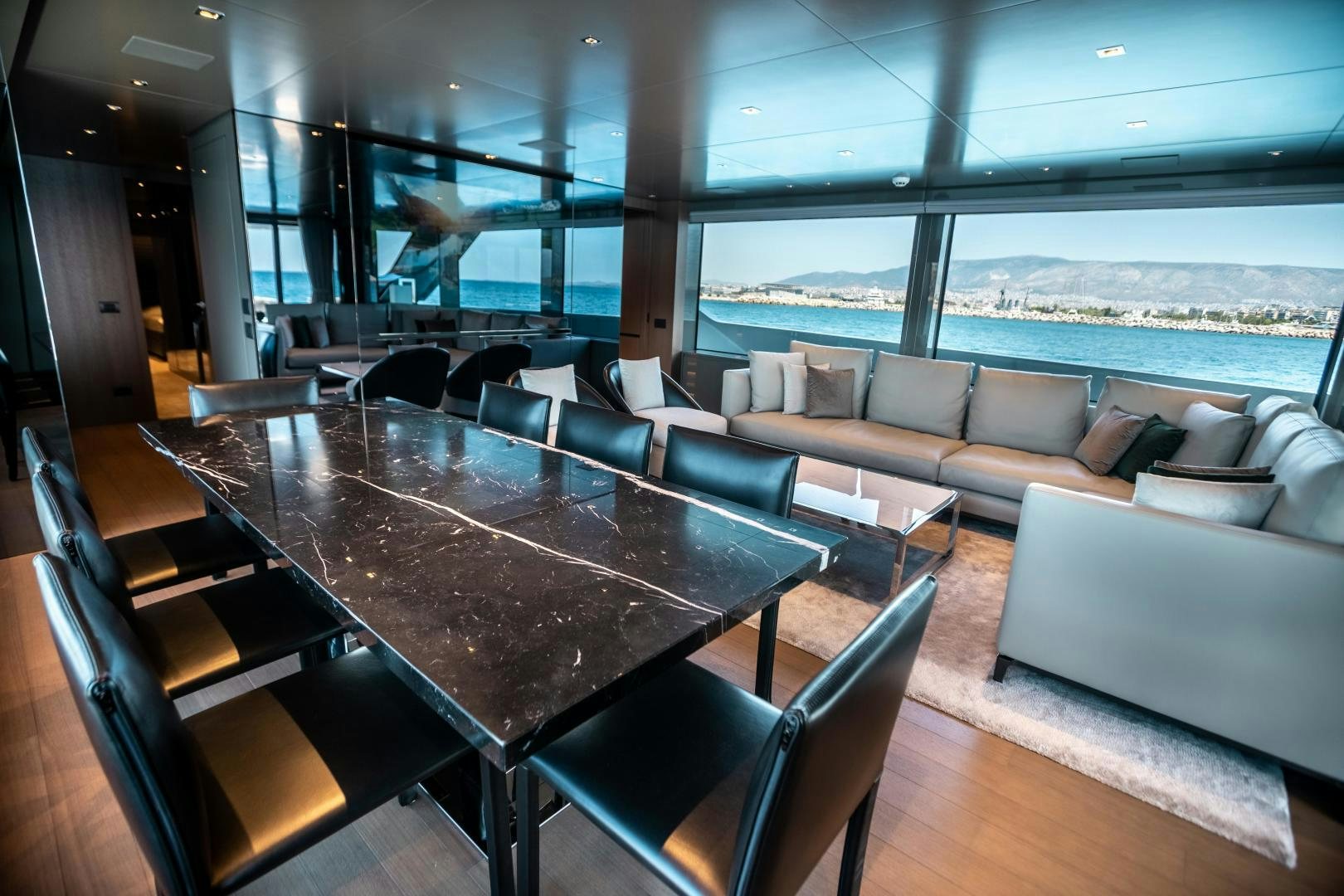 a large room with a table and chairs aboard ACE Yacht for Sale