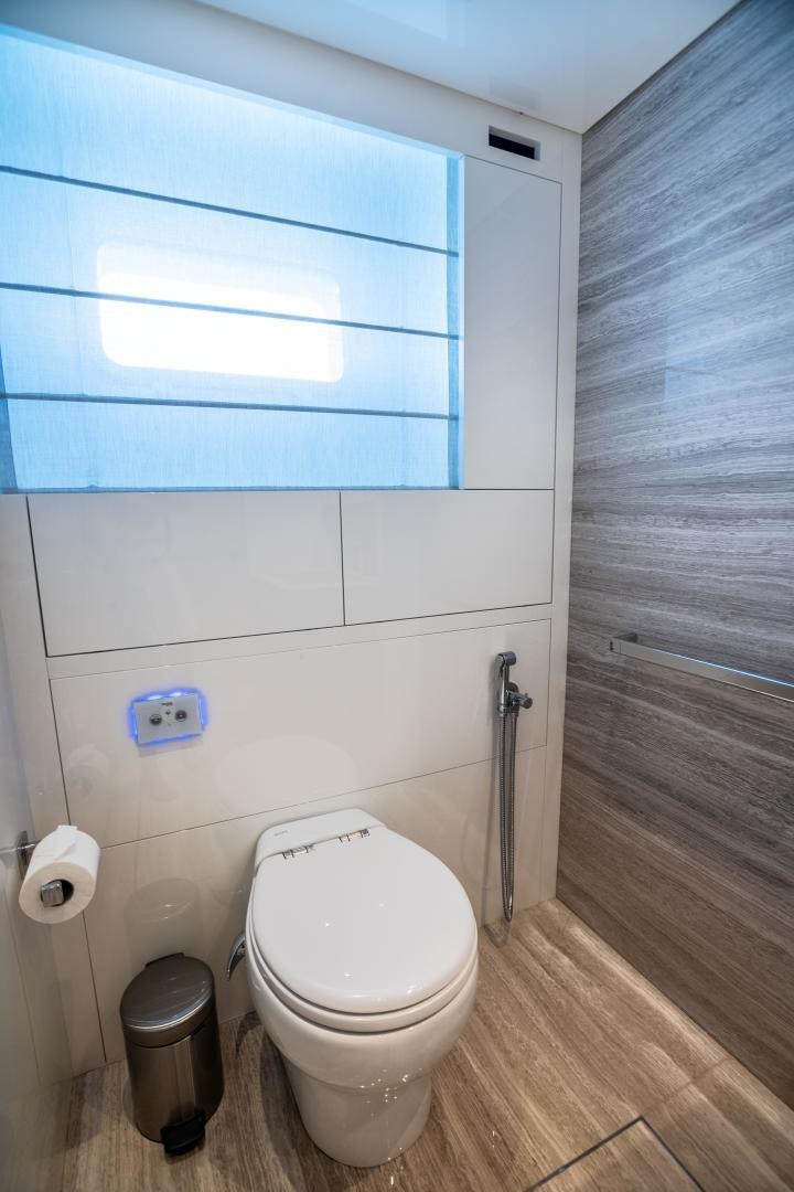 a bathroom with a toilet and a trash can aboard ACE Yacht for Sale