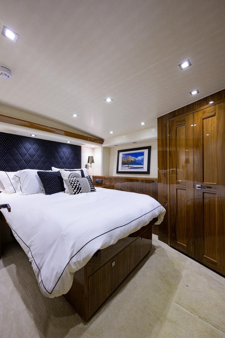 a bedroom with a bed and a television aboard SET IN MY WAVES Yacht for Sale