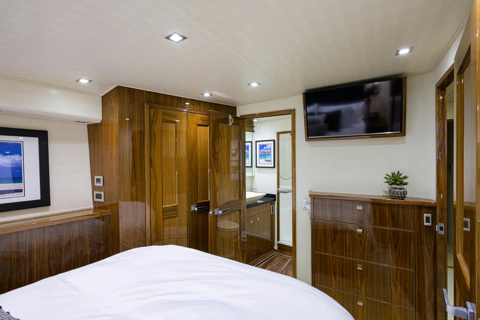 a hotel room with a bed and tv aboard SET IN MY WAVES Yacht for Sale