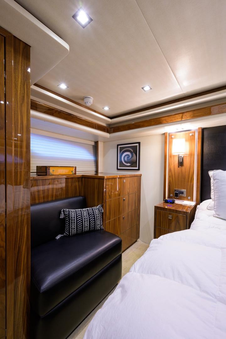 a bedroom with a bed and a desk aboard SET IN MY WAVES Yacht for Sale