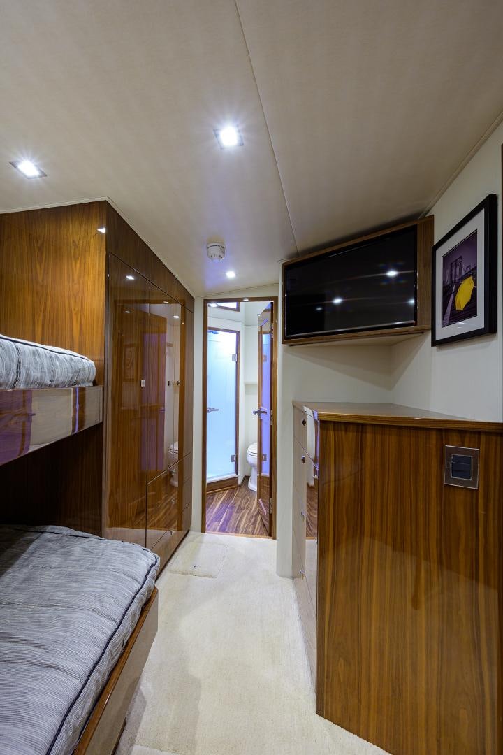 a bedroom with a wood floor aboard SET IN MY WAVES Yacht for Sale