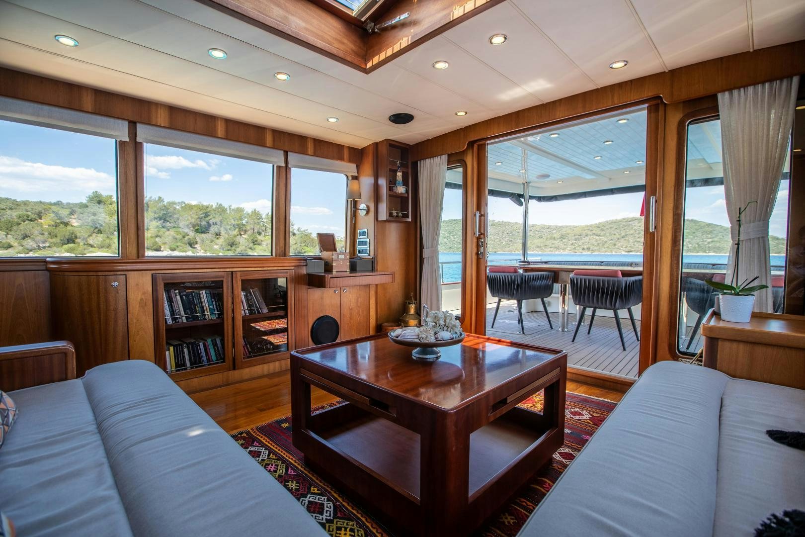 a living room with a table and chairs aboard DILNISIN Yacht for Sale