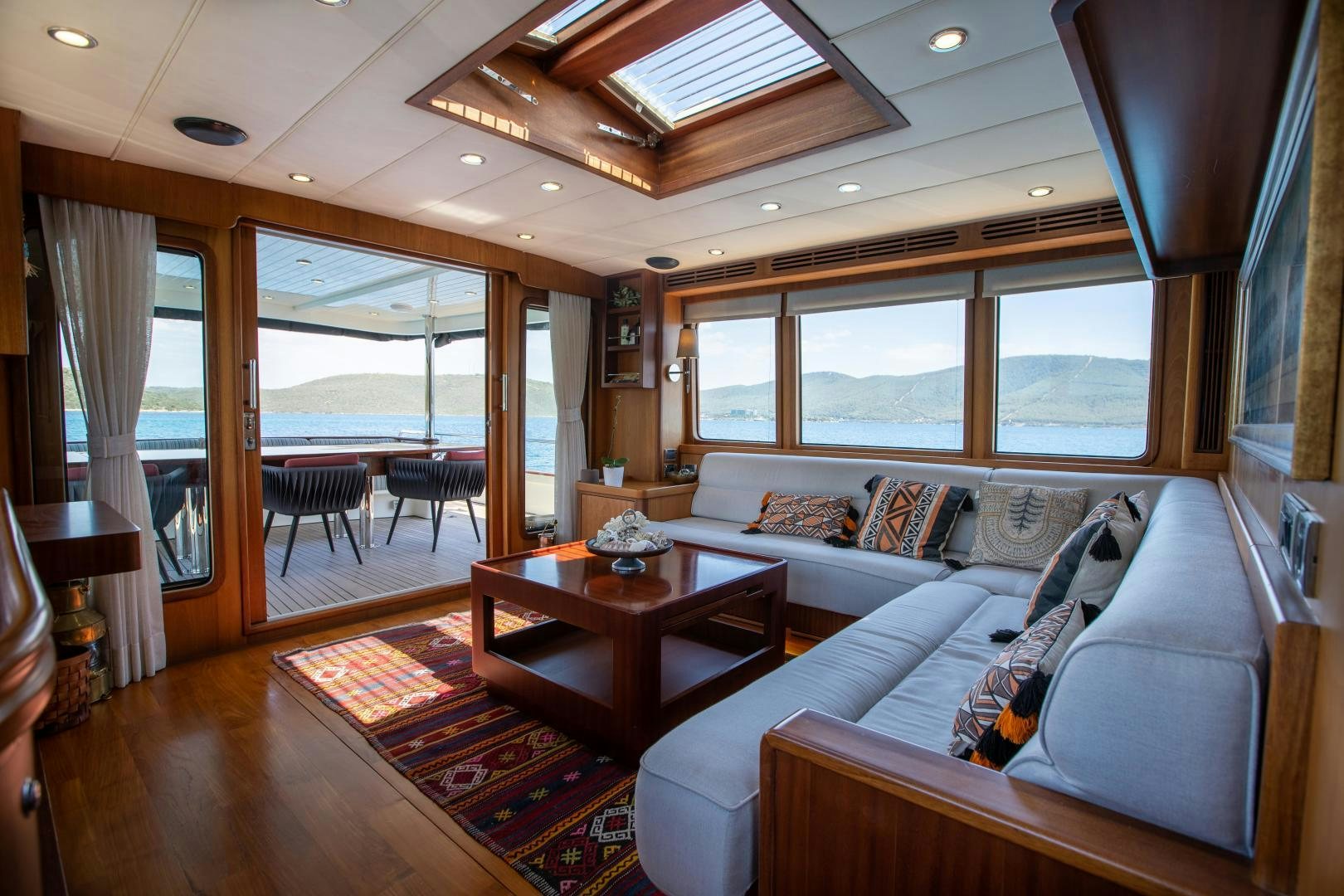 a living room with a large window aboard DILNISIN Yacht for Sale