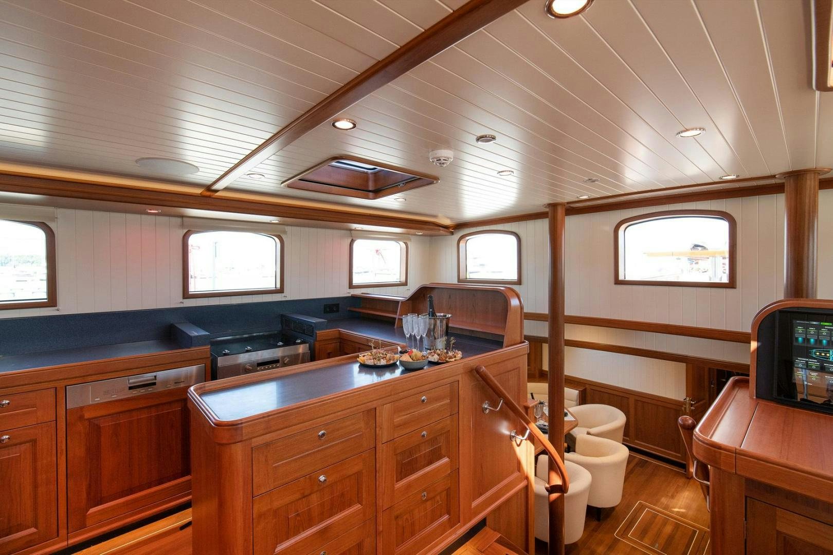 a kitchen with wooden cabinets aboard MELODY Yacht for Sale