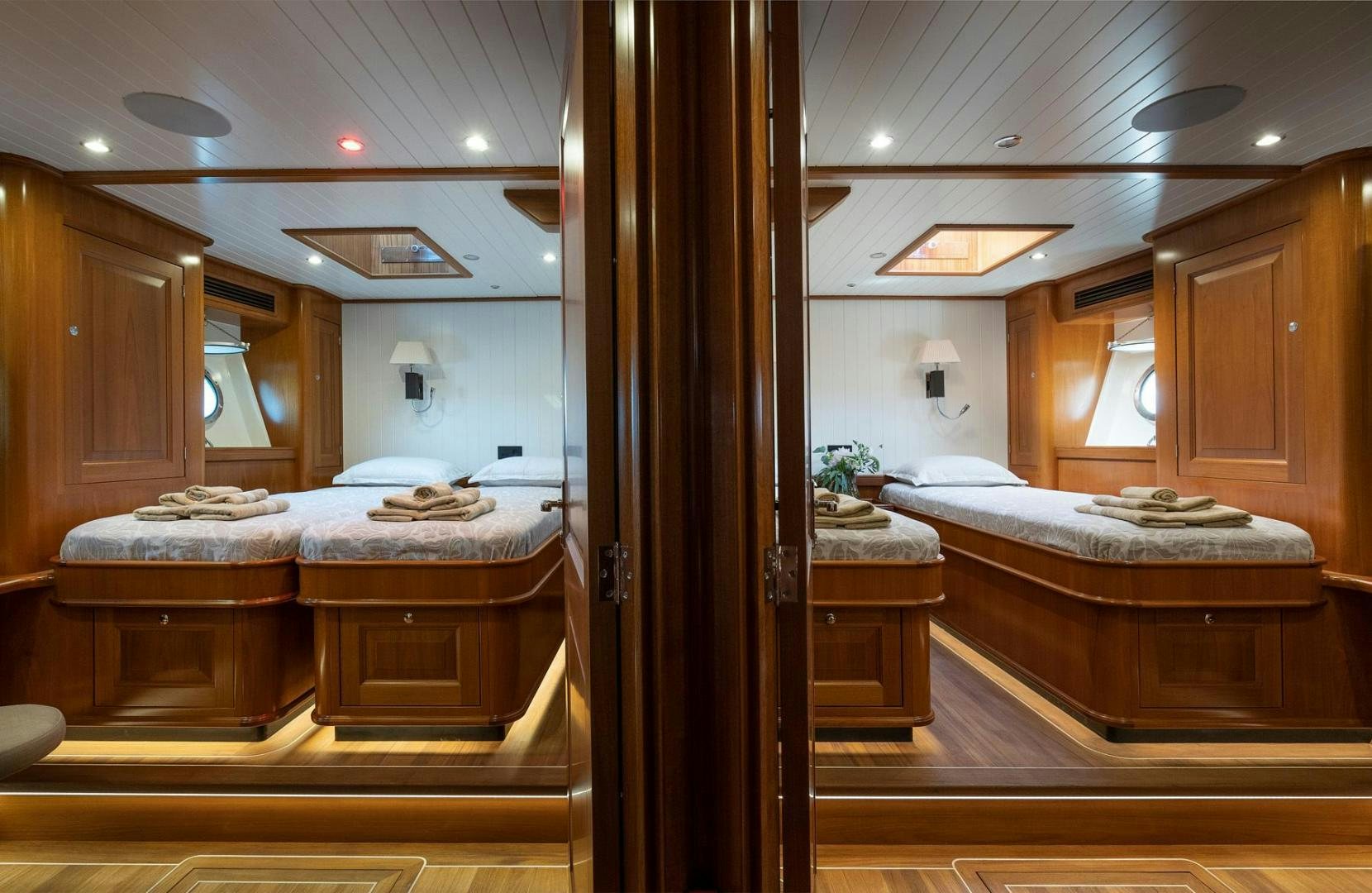a room with a bed and a mirror aboard MELODY Yacht for Sale