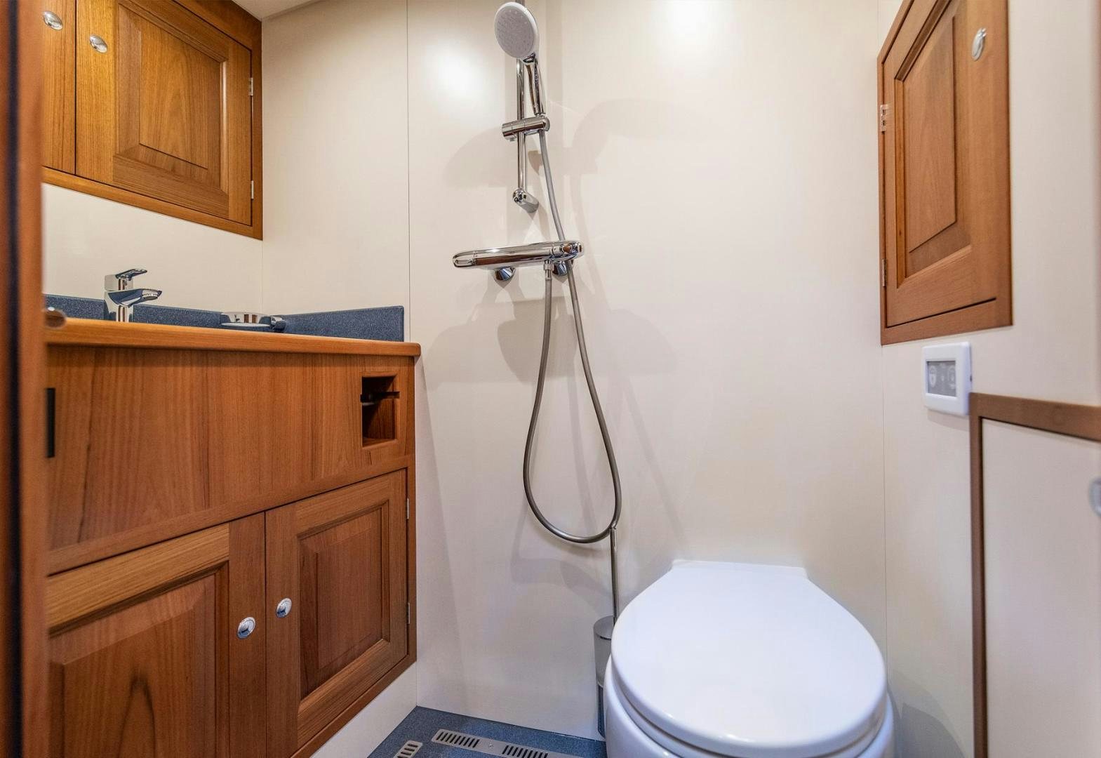 a toilet with a shower head aboard MELODY Yacht for Sale