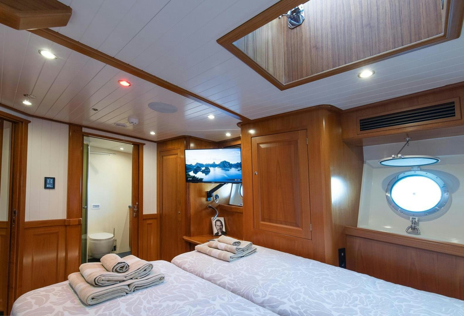 a bedroom with a large bed aboard MELODY Yacht for Sale