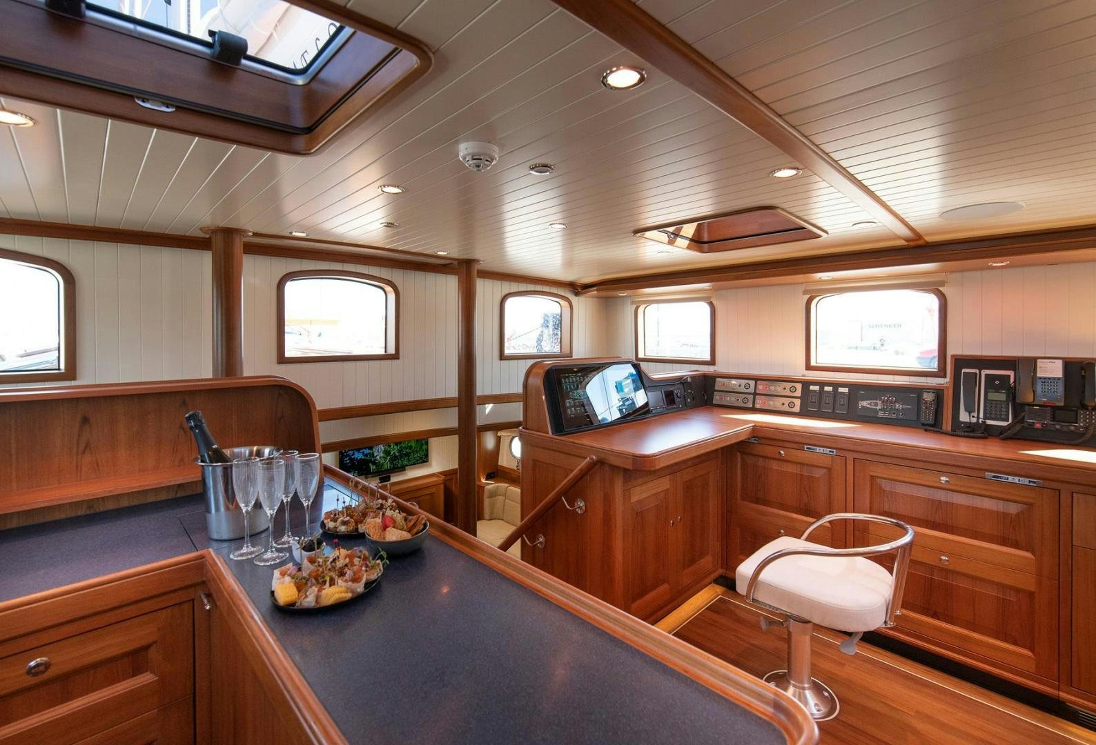 a kitchen with wooden cabinets aboard MELODY Yacht for Sale
