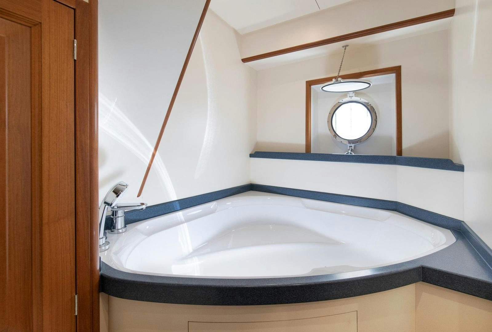 a bathroom with a tub aboard MELODY Yacht for Sale
