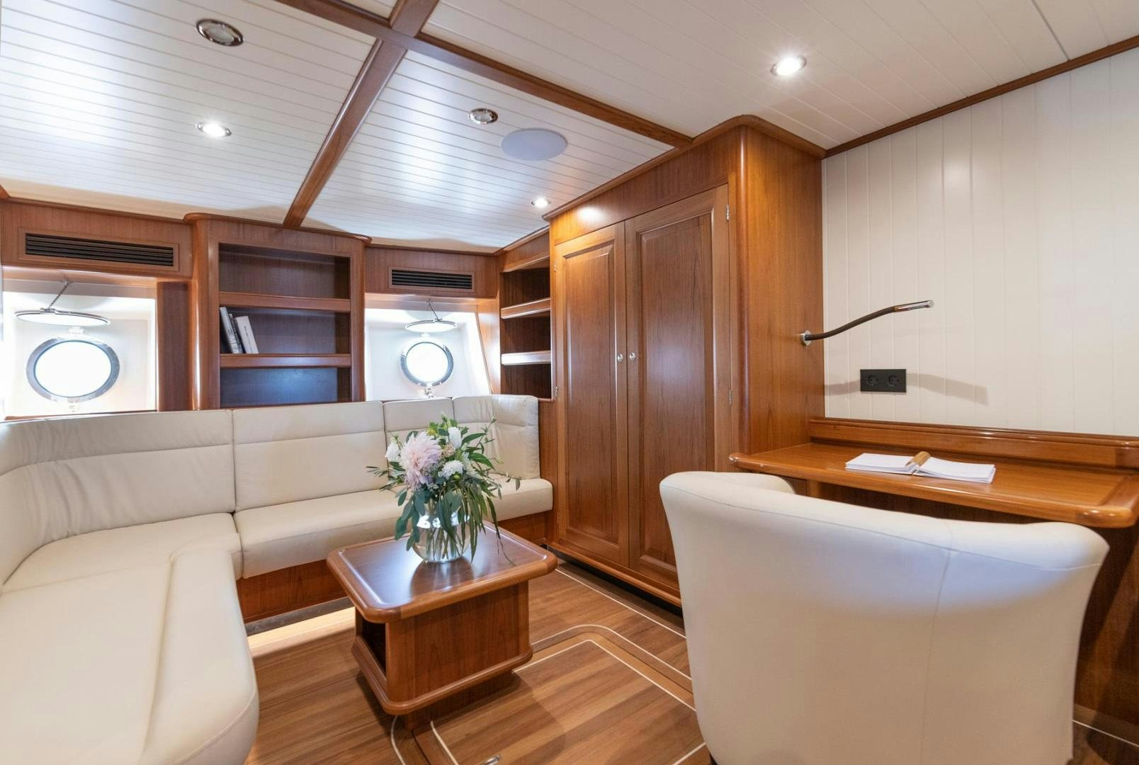 a living room with a couch and a table aboard MELODY Yacht for Sale