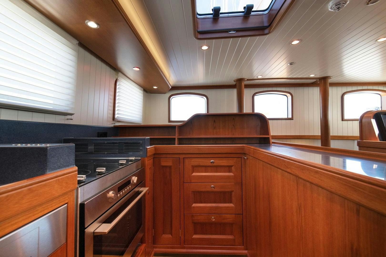a kitchen with wooden cabinets aboard MELODY Yacht for Sale