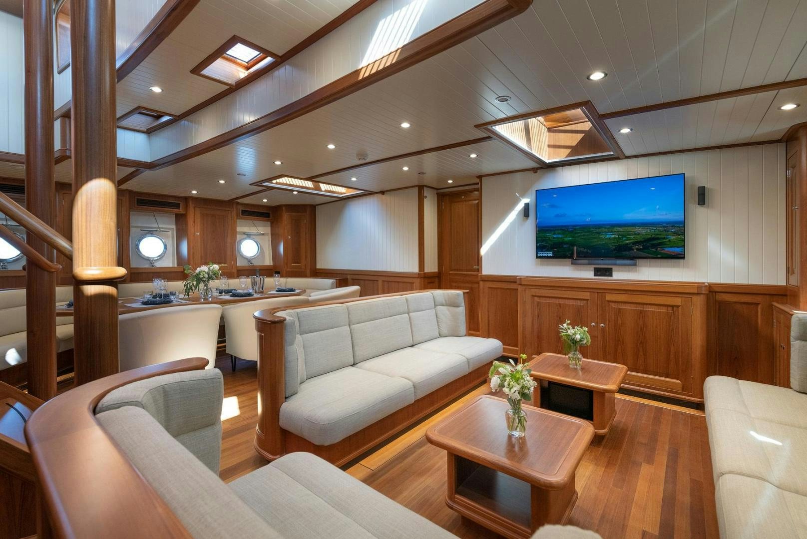 a living room with a large screen aboard MELODY Yacht for Sale