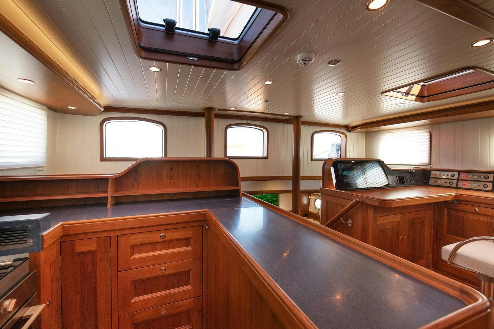 a kitchen with wooden cabinets aboard MELODY Yacht for Sale