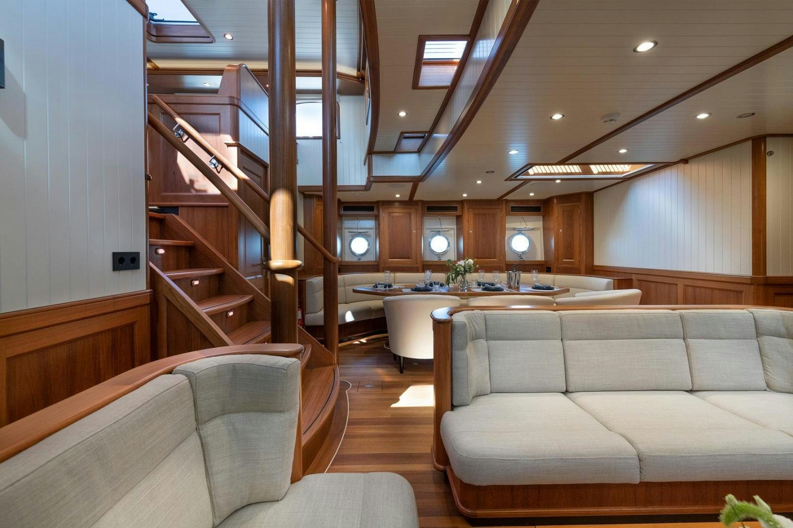 a living room with a staircase aboard MELODY Yacht for Sale