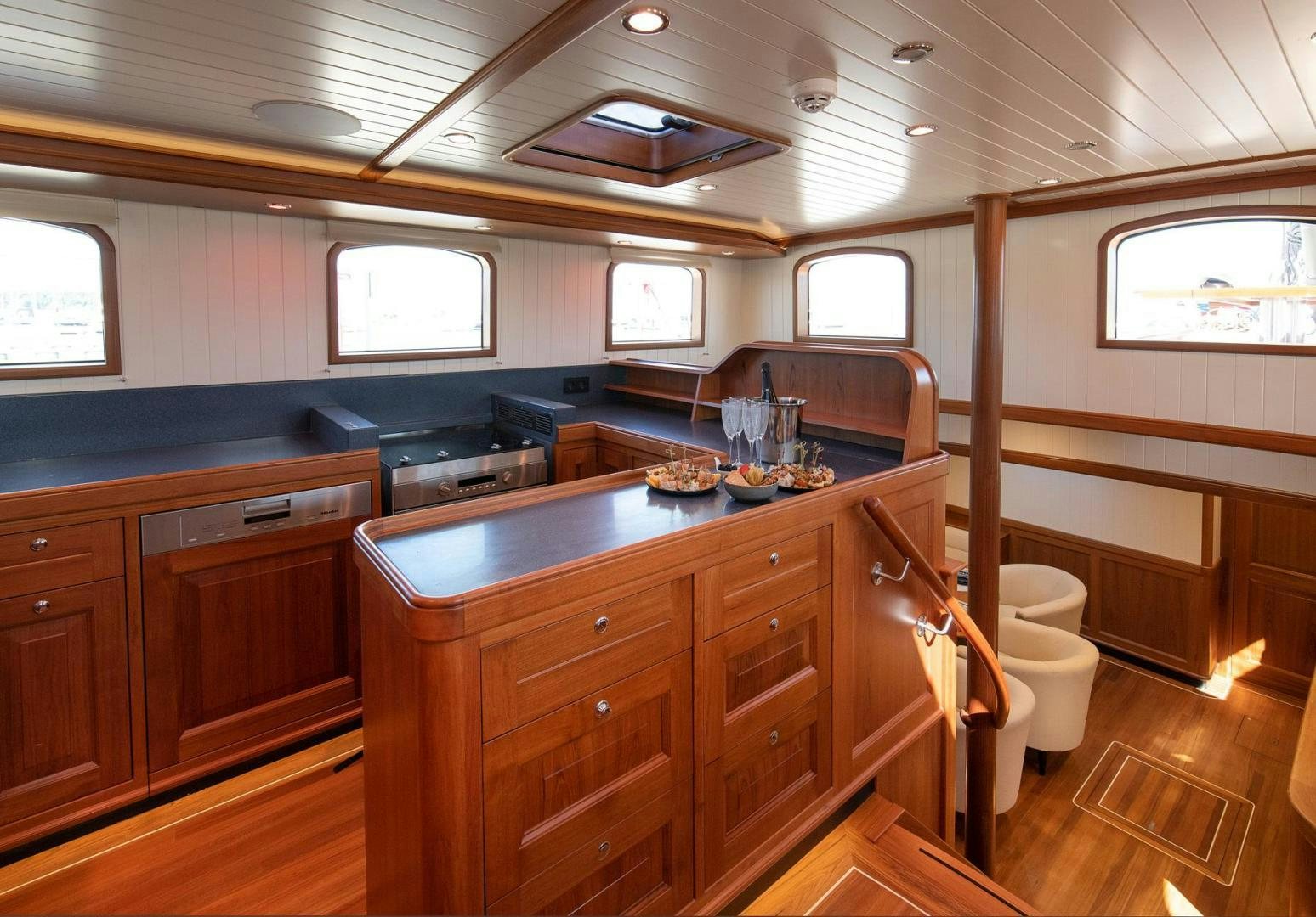 a kitchen with wooden cabinets aboard MELODY Yacht for Sale