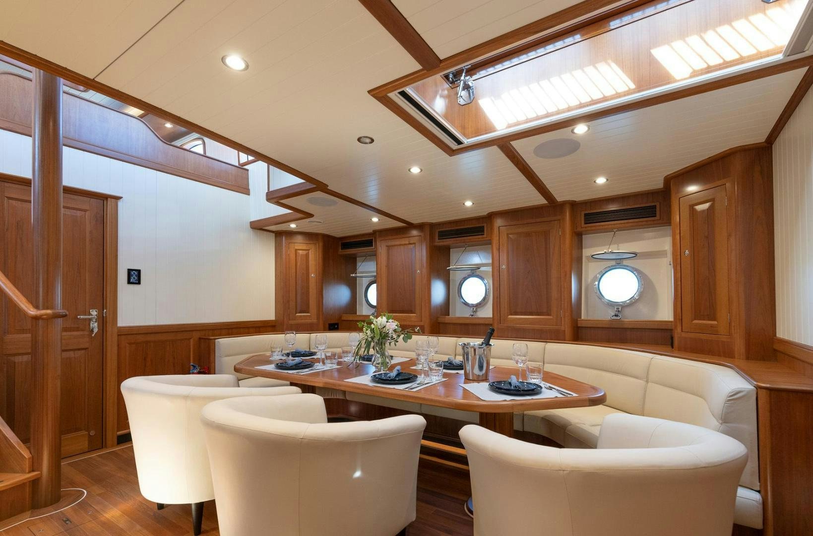 a room with a table and chairs aboard MELODY Yacht for Sale