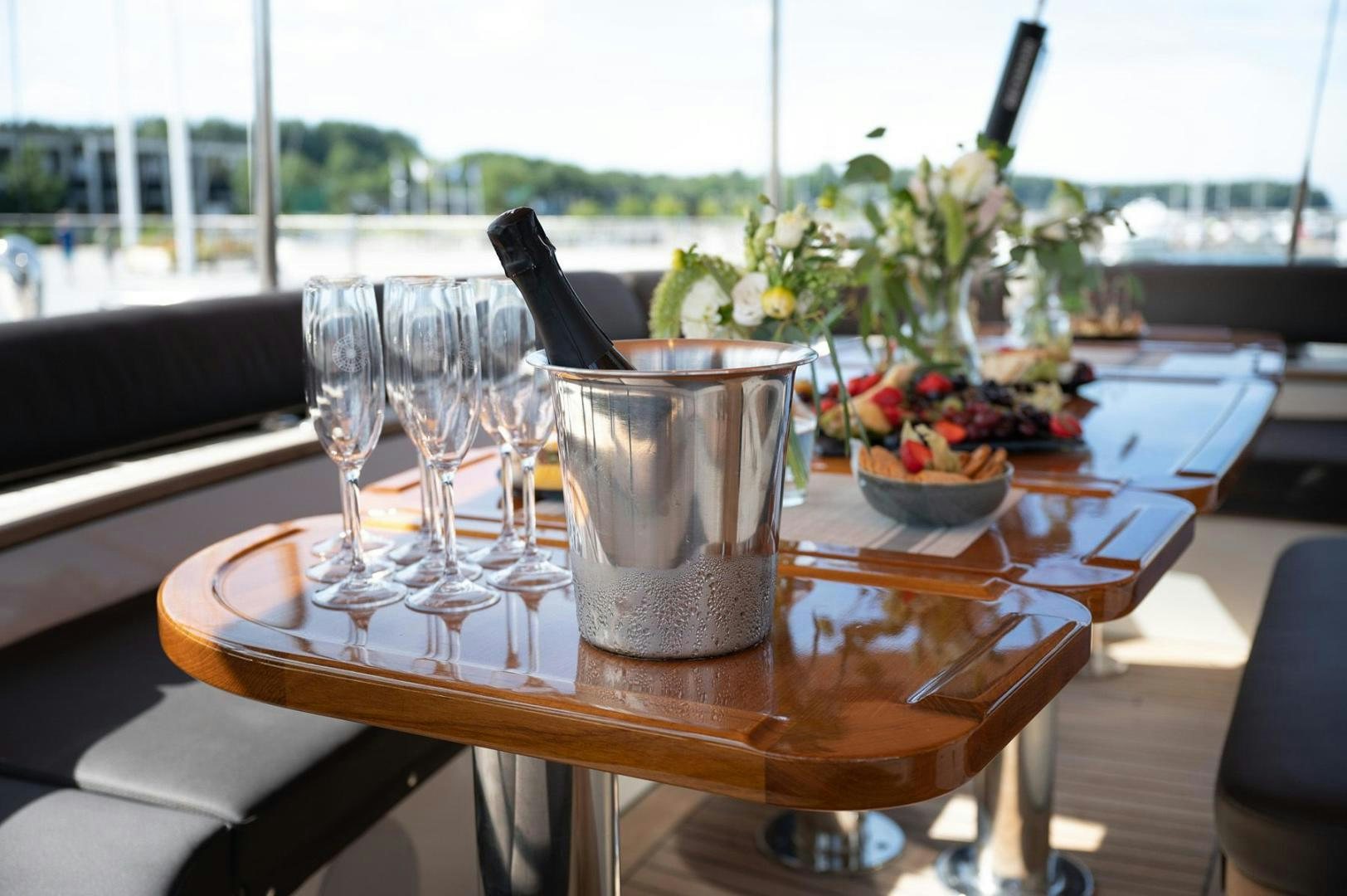 a table with glasses and food on it aboard MELODY Yacht for Sale