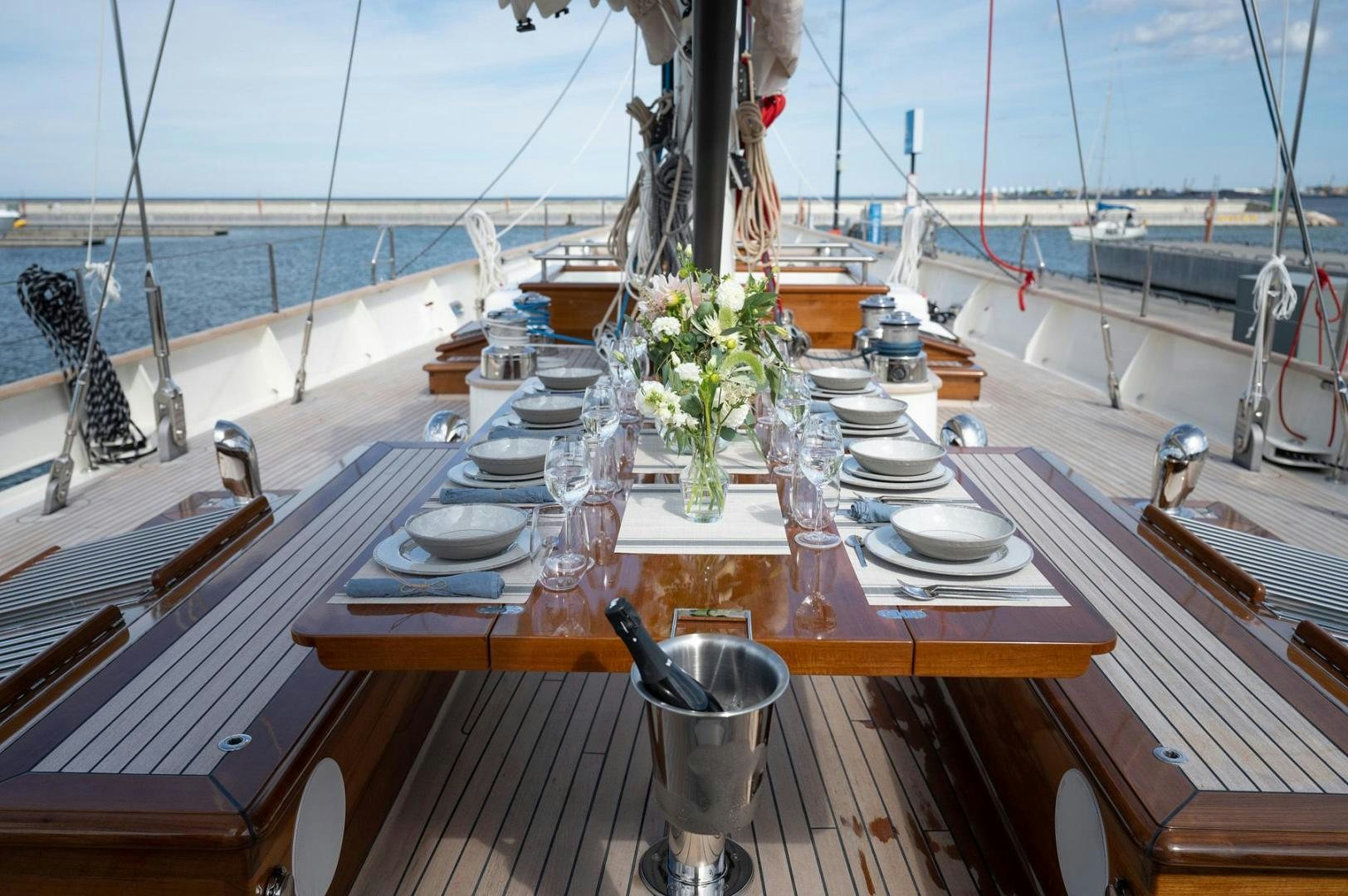 a table with plates and glasses on it aboard MELODY Yacht for Sale