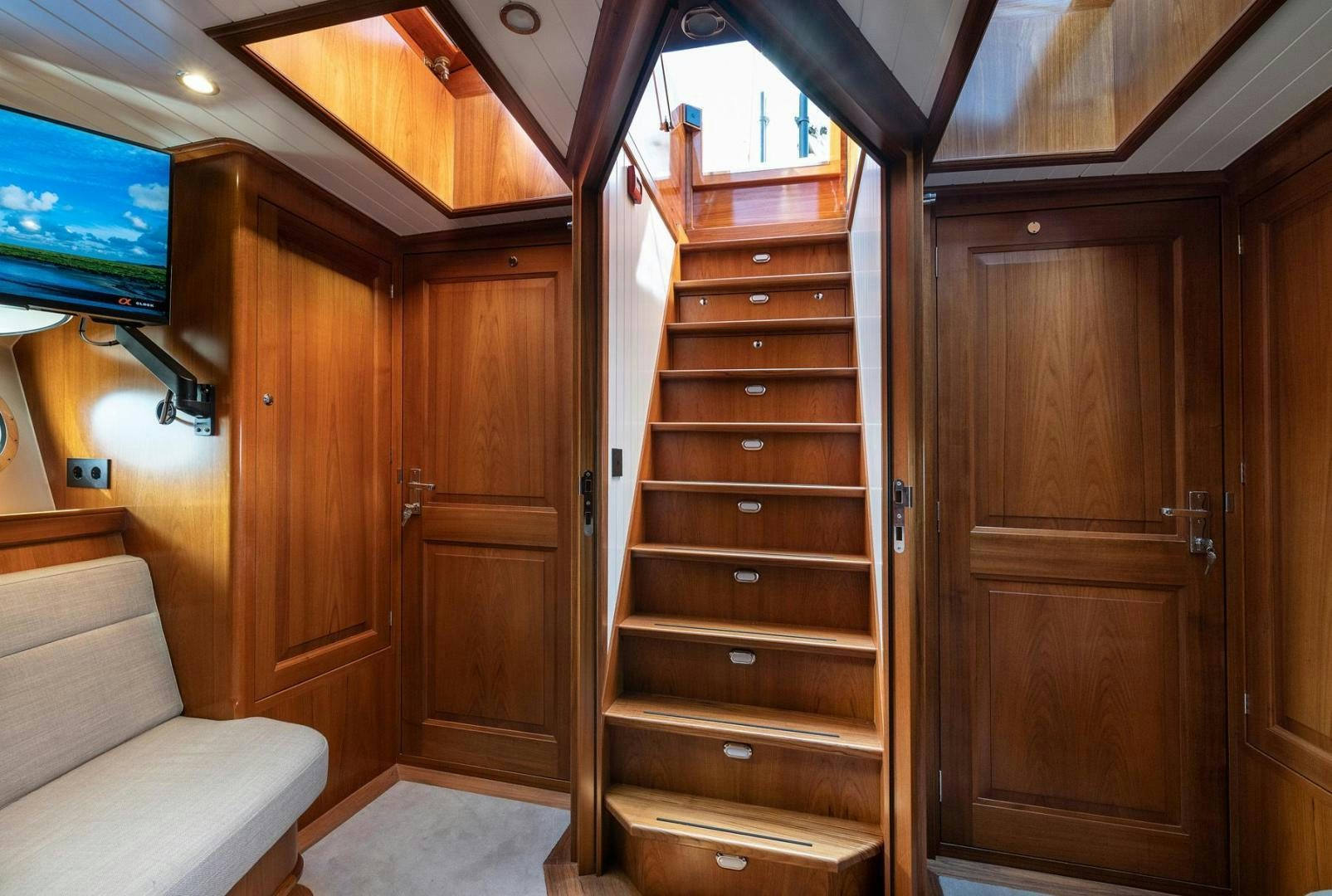a room with wooden cabinets aboard MELODY Yacht for Sale
