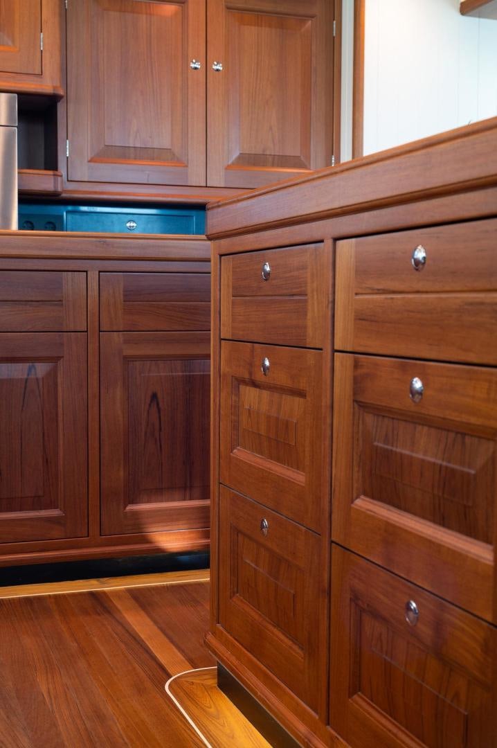 a wooden cabinet with drawers aboard MELODY Yacht for Sale