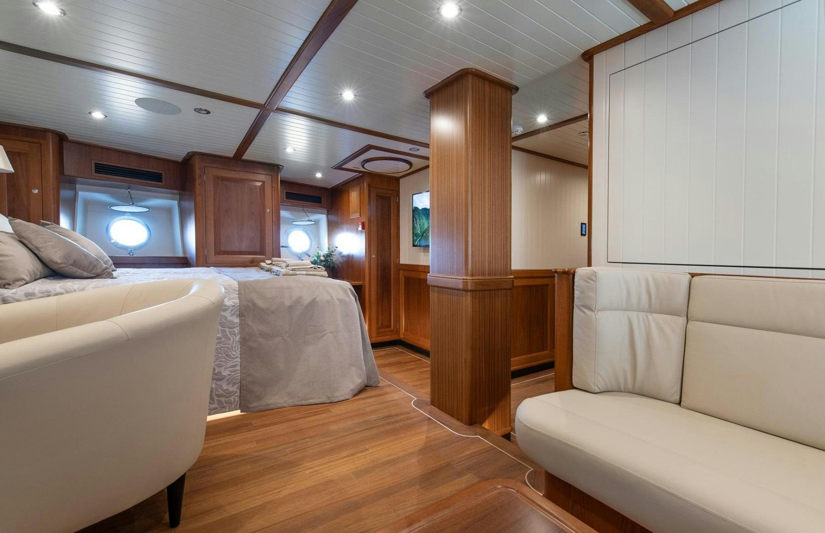 a room with a bed and a couch aboard MELODY Yacht for Sale