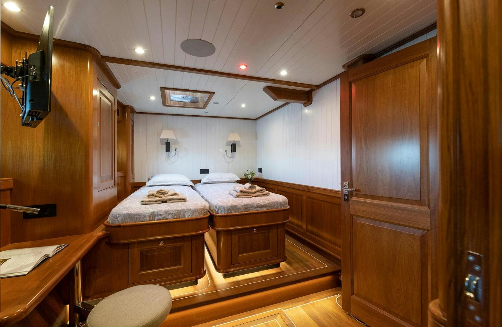 a room with a bed and a desk aboard MELODY Yacht for Sale