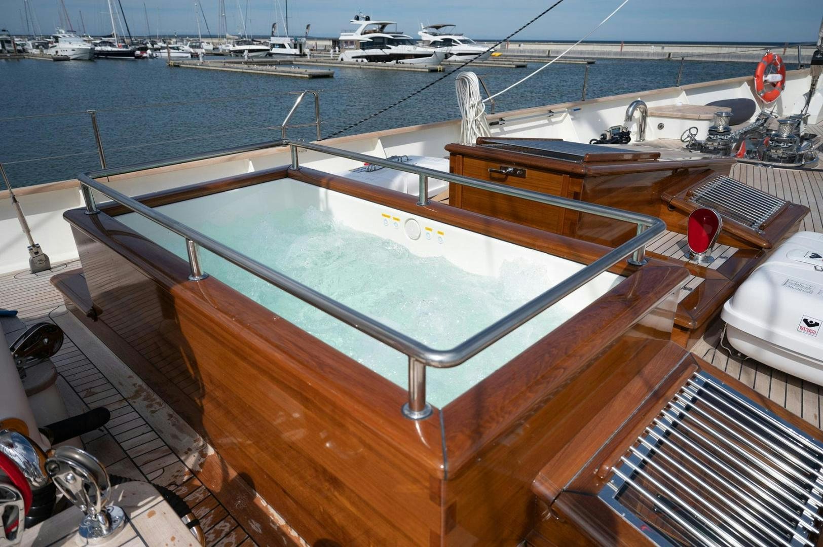 a deck with a large deck overlooking a body of water aboard MELODY Yacht for Sale