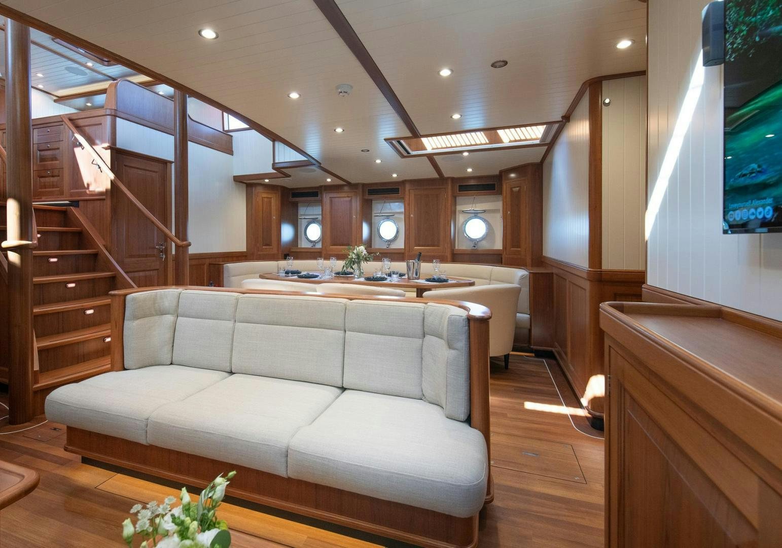a living room with a white couch aboard MELODY Yacht for Sale