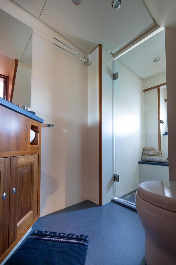 a bathroom with a blue rug aboard MELODY Yacht for Sale