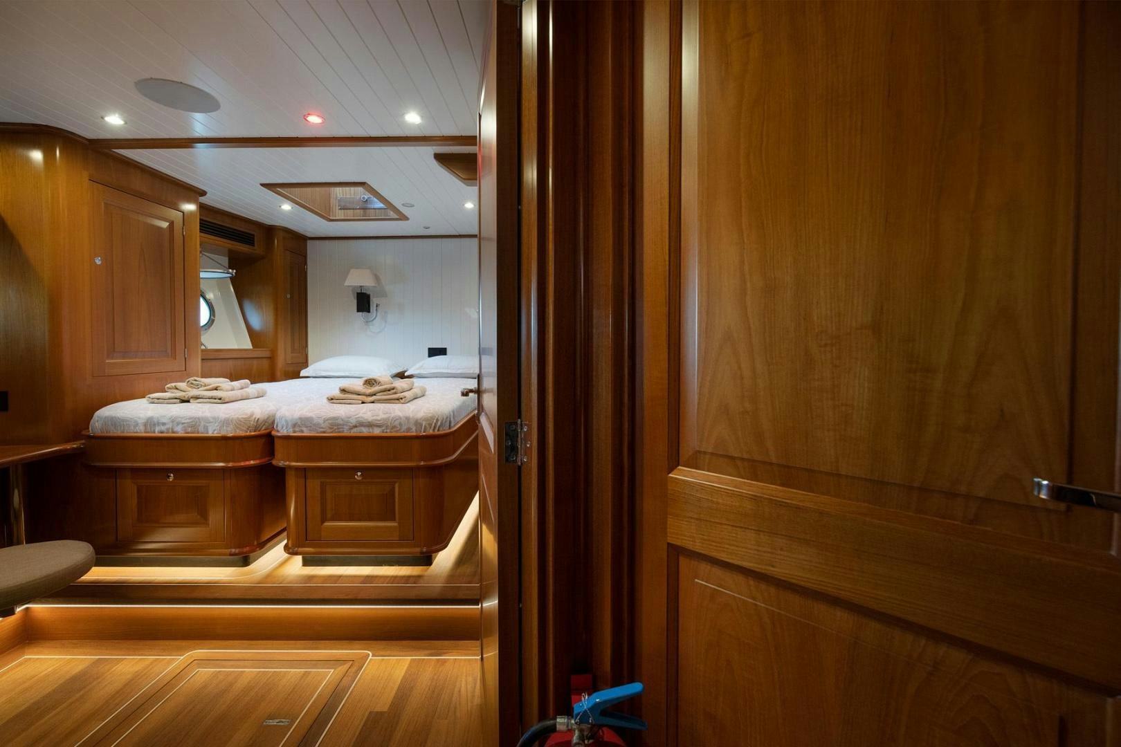 a room with a bed and a closet aboard MELODY Yacht for Sale