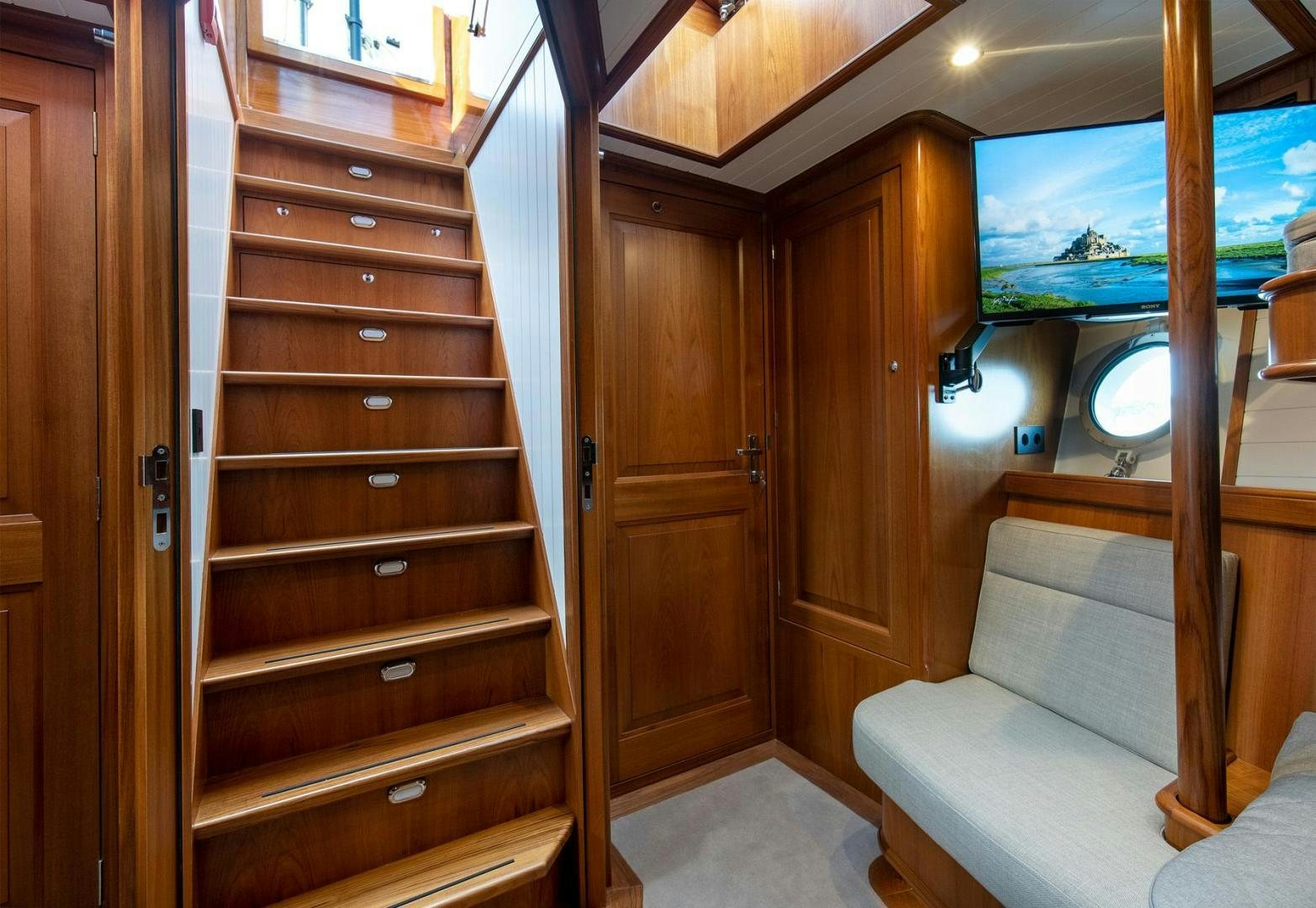 a room with wooden cabinets aboard MELODY Yacht for Sale