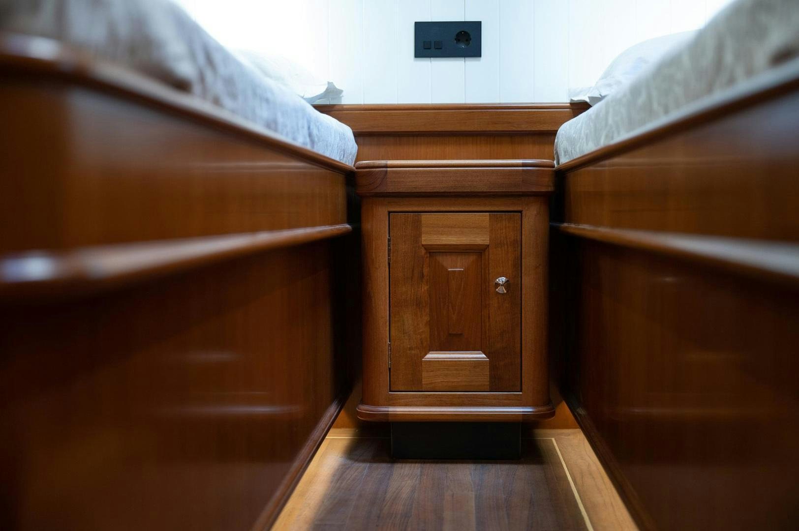 a wooden dresser in a room aboard MELODY Yacht for Sale