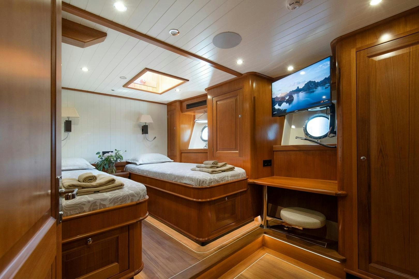 a bedroom with a bed and a mirror aboard MELODY Yacht for Sale