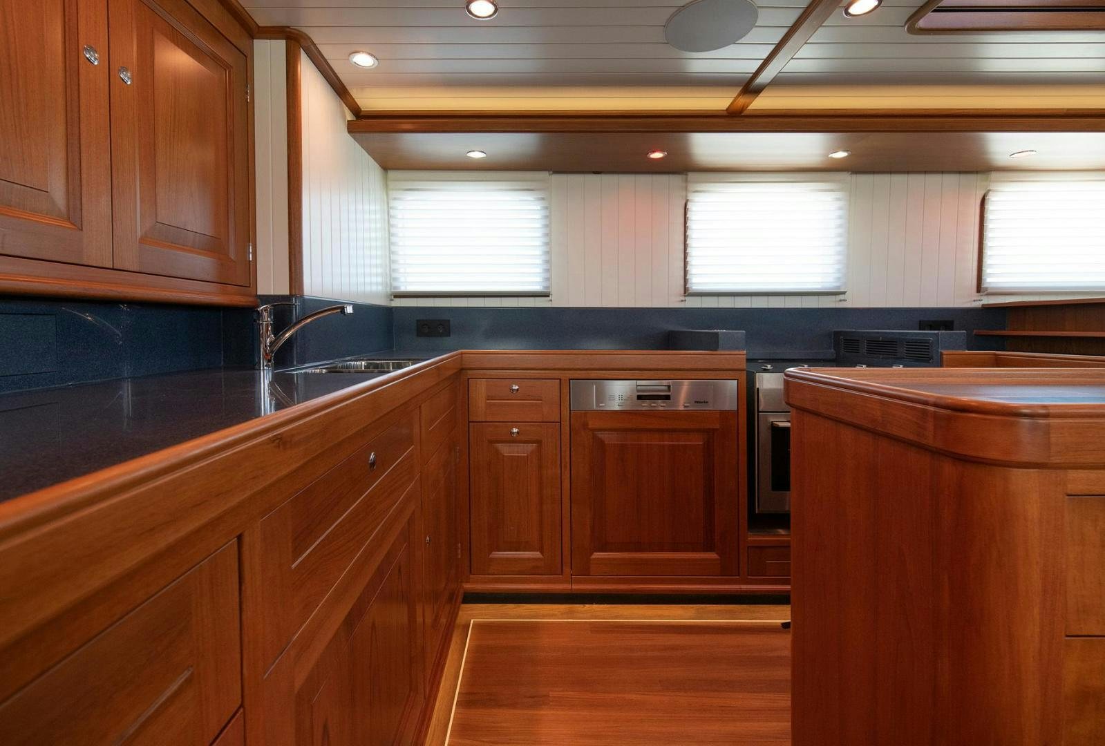 a kitchen with wooden cabinets aboard MELODY Yacht for Sale