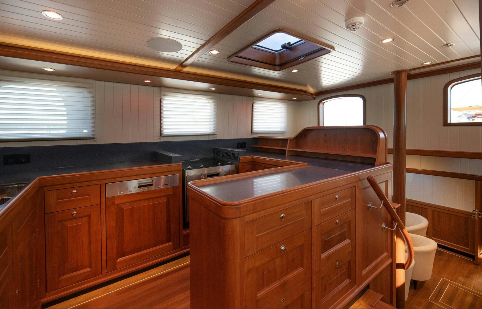 a kitchen with wooden cabinets aboard MELODY Yacht for Sale