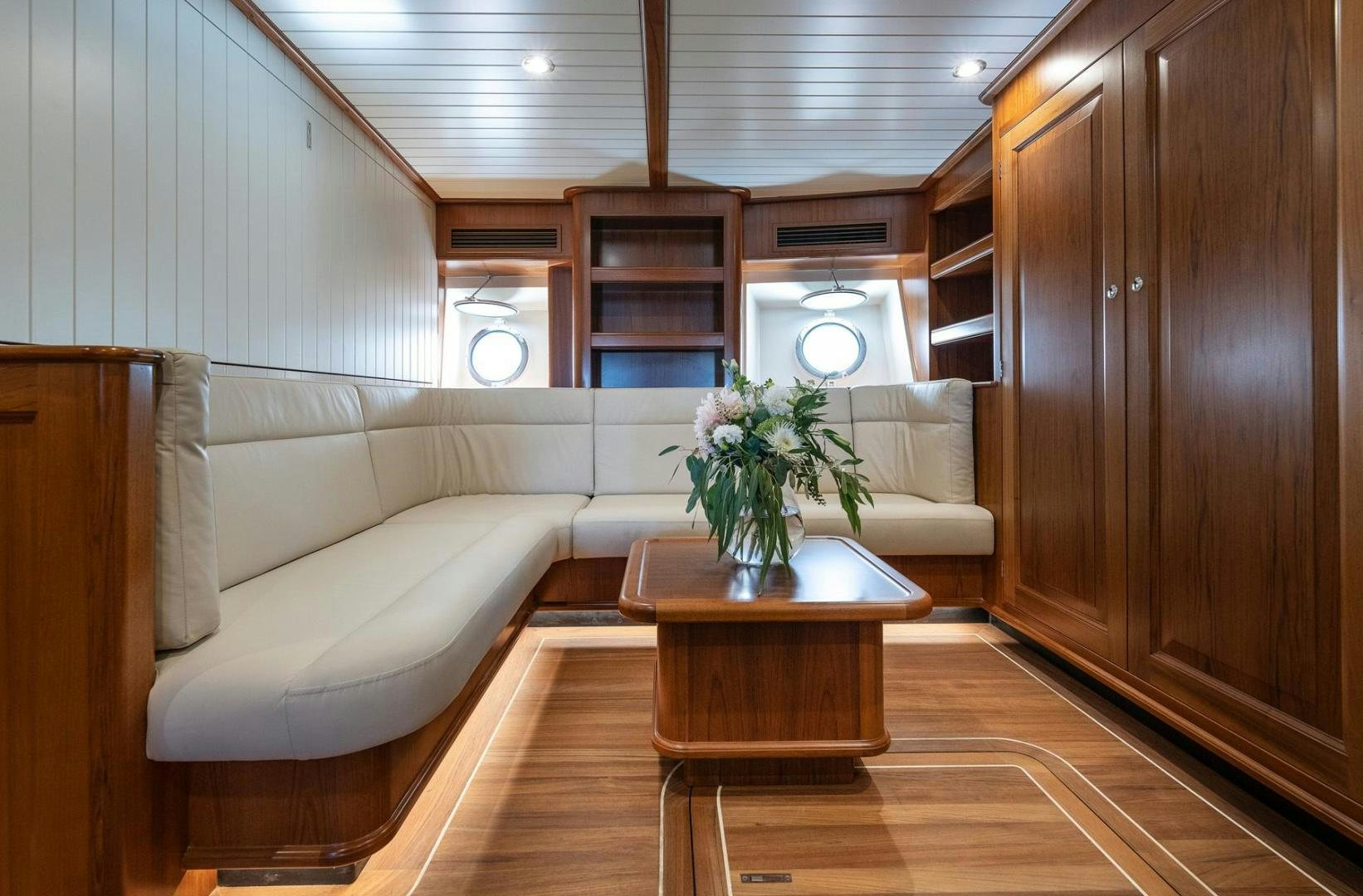 a living room with a couch and a coffee table aboard MELODY Yacht for Sale