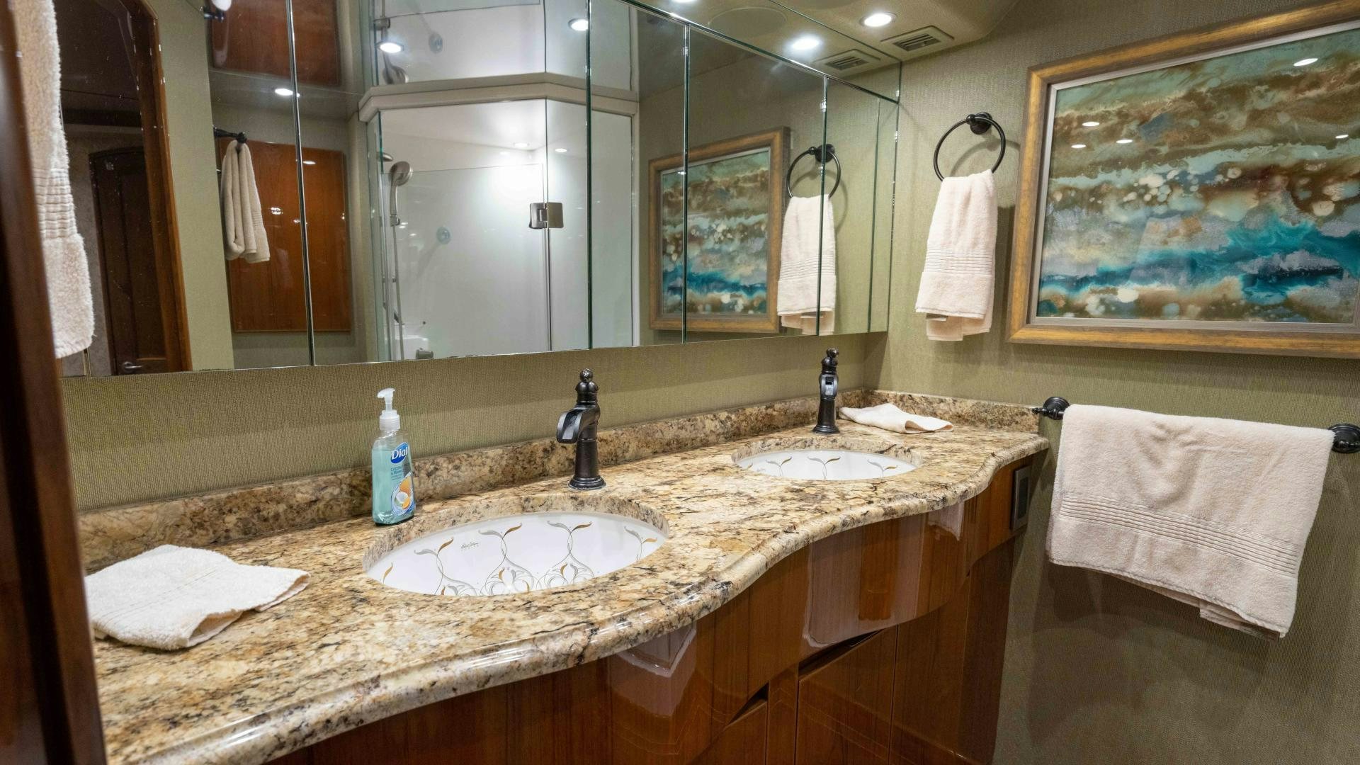 a bathroom with a large mirror aboard HOW SWEET IT IS Yacht for Sale