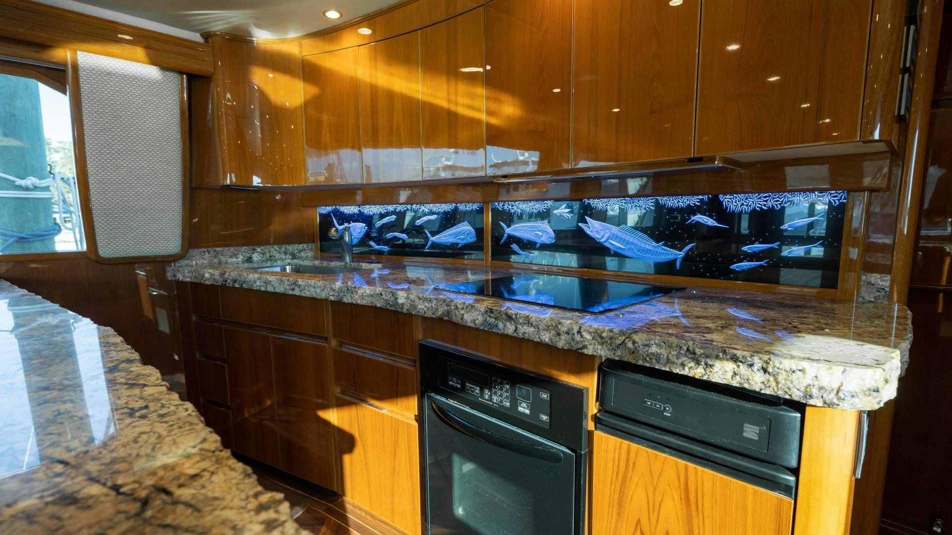 a kitchen with a marble counter top aboard HOW SWEET IT IS Yacht for Sale
