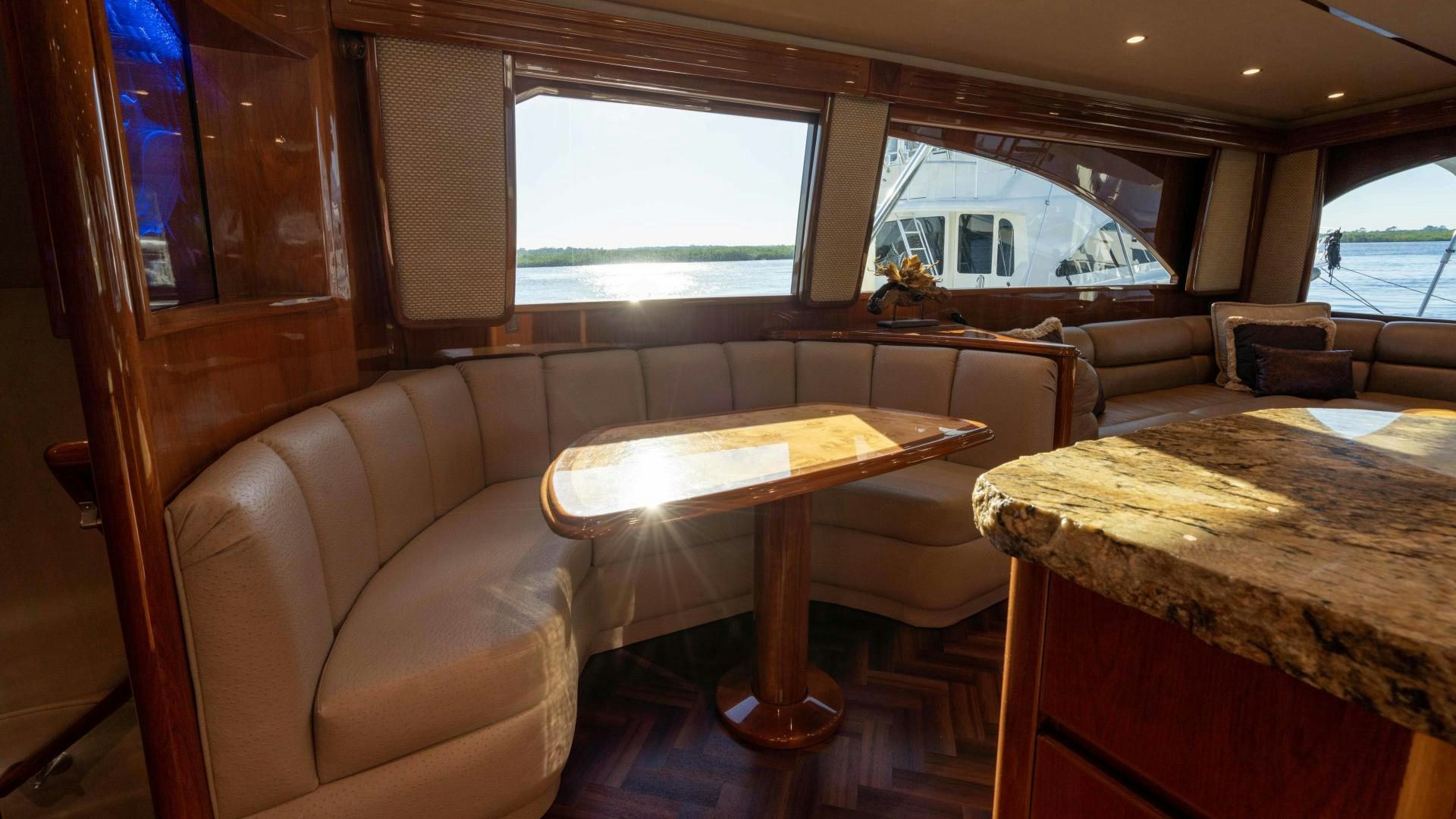 a living room with a couch and a table aboard HOW SWEET IT IS Yacht for Sale