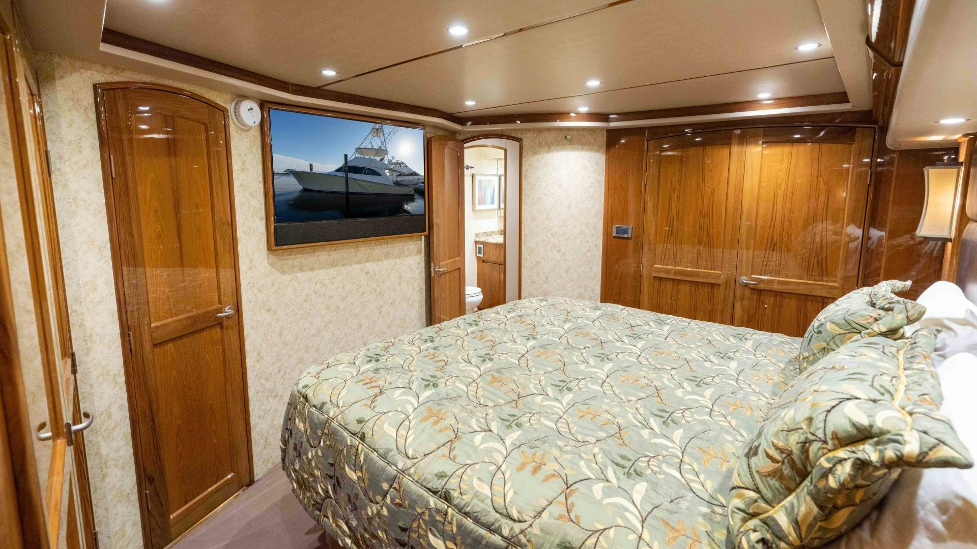 a bed in a room aboard HOW SWEET IT IS Yacht for Sale