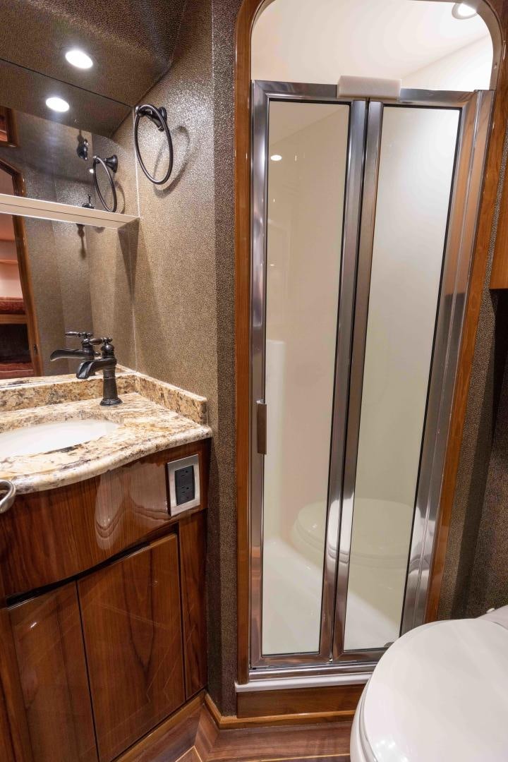 a bathroom with a glass shower aboard HOW SWEET IT IS Yacht for Sale