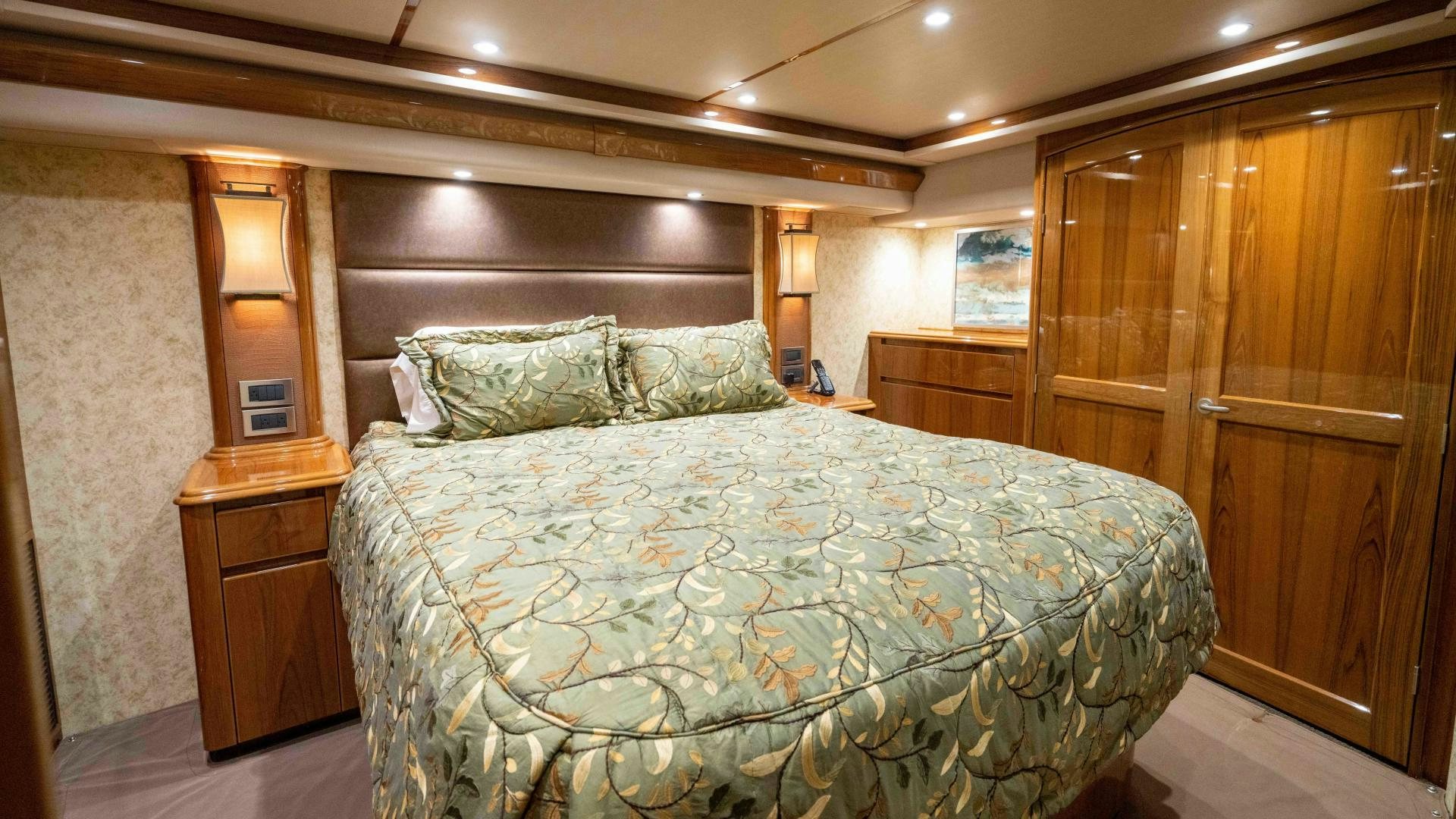 a bed in a room aboard HOW SWEET IT IS Yacht for Sale