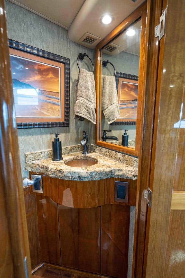 a bathroom with a sink and a mirror aboard HOW SWEET IT IS Yacht for Sale