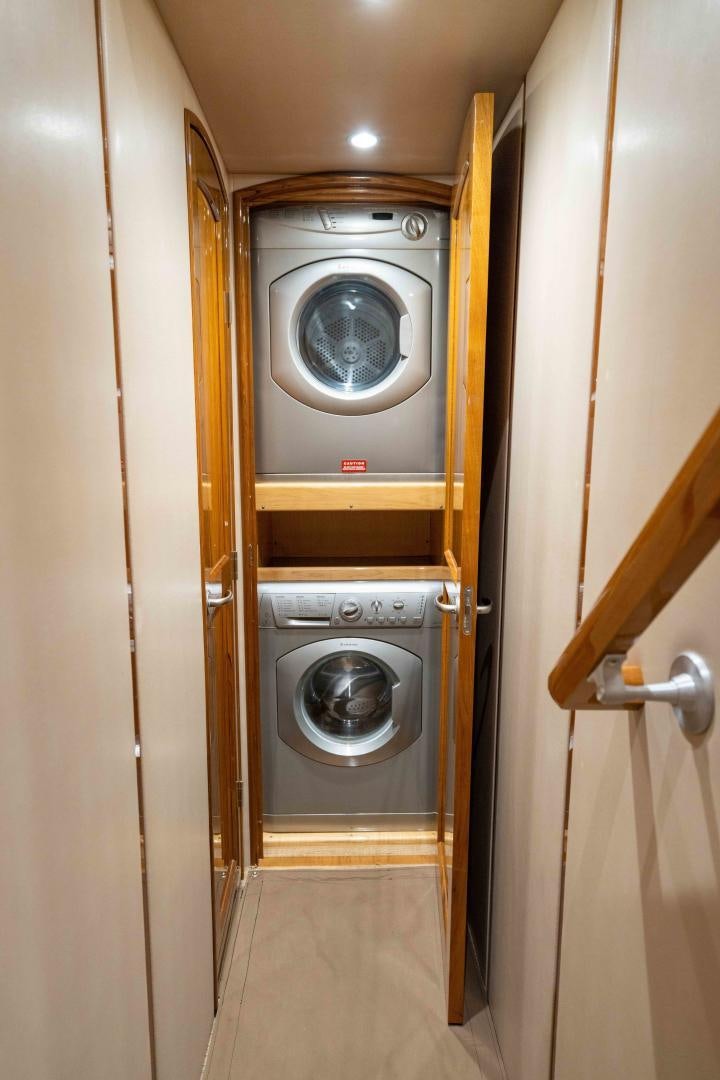a washer and dryer in a room aboard HOW SWEET IT IS Yacht for Sale