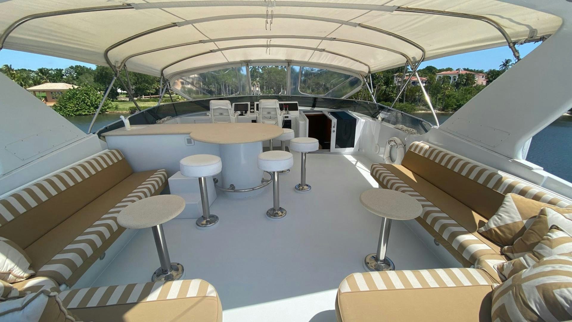 a room with tables and chairs aboard SOCIAL DIRECTOR Yacht for Sale