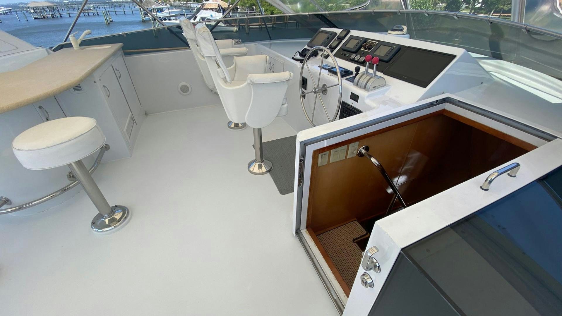 a boat with a seat and a seat on the deck aboard SOCIAL DIRECTOR Yacht for Sale