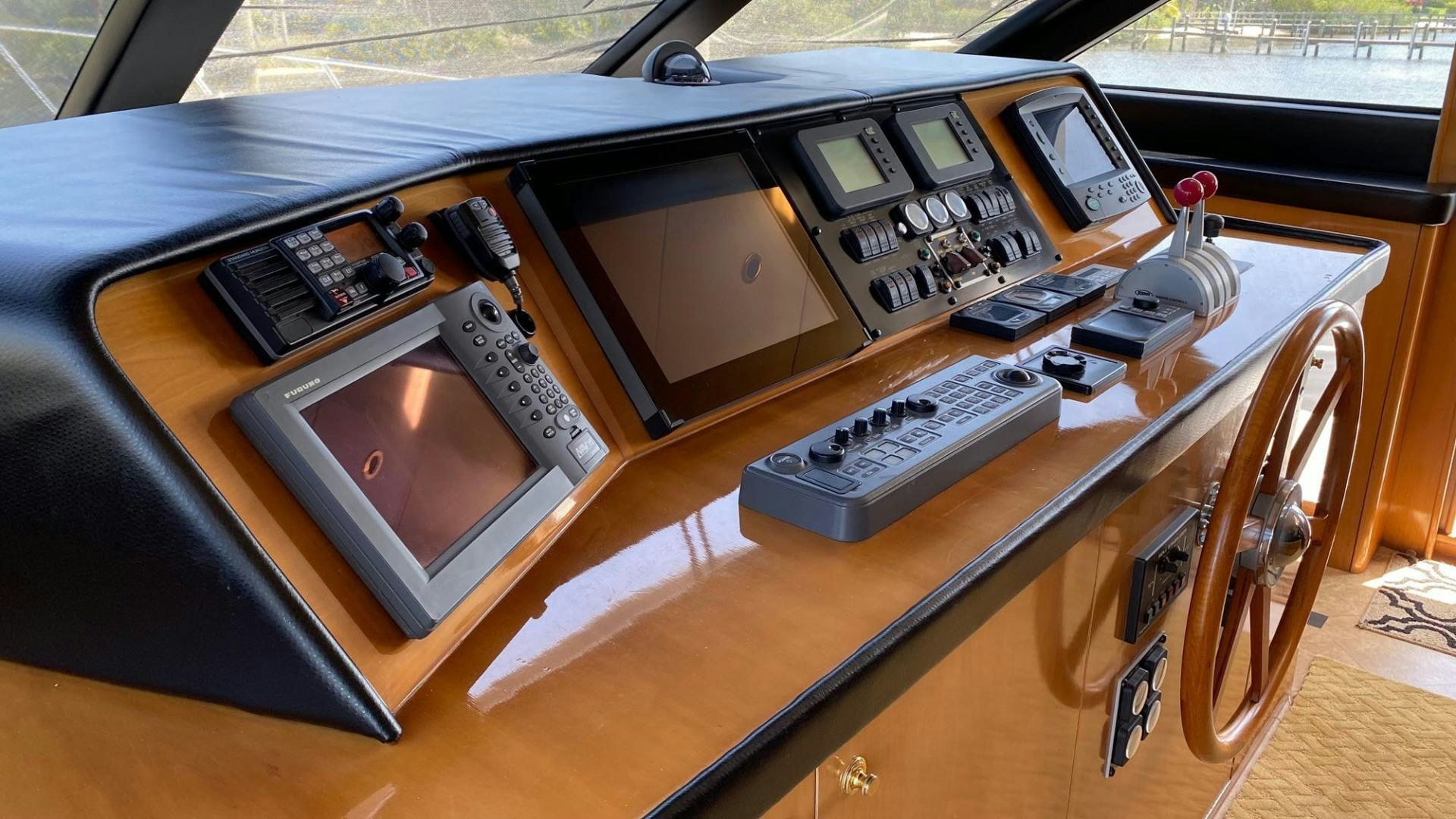 a wooden desk with a laptop and other electronics on it aboard SOCIAL DIRECTOR Yacht for Sale
